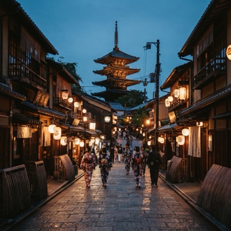 Lantern-lit street in Kyoto at dusk with a pagoda